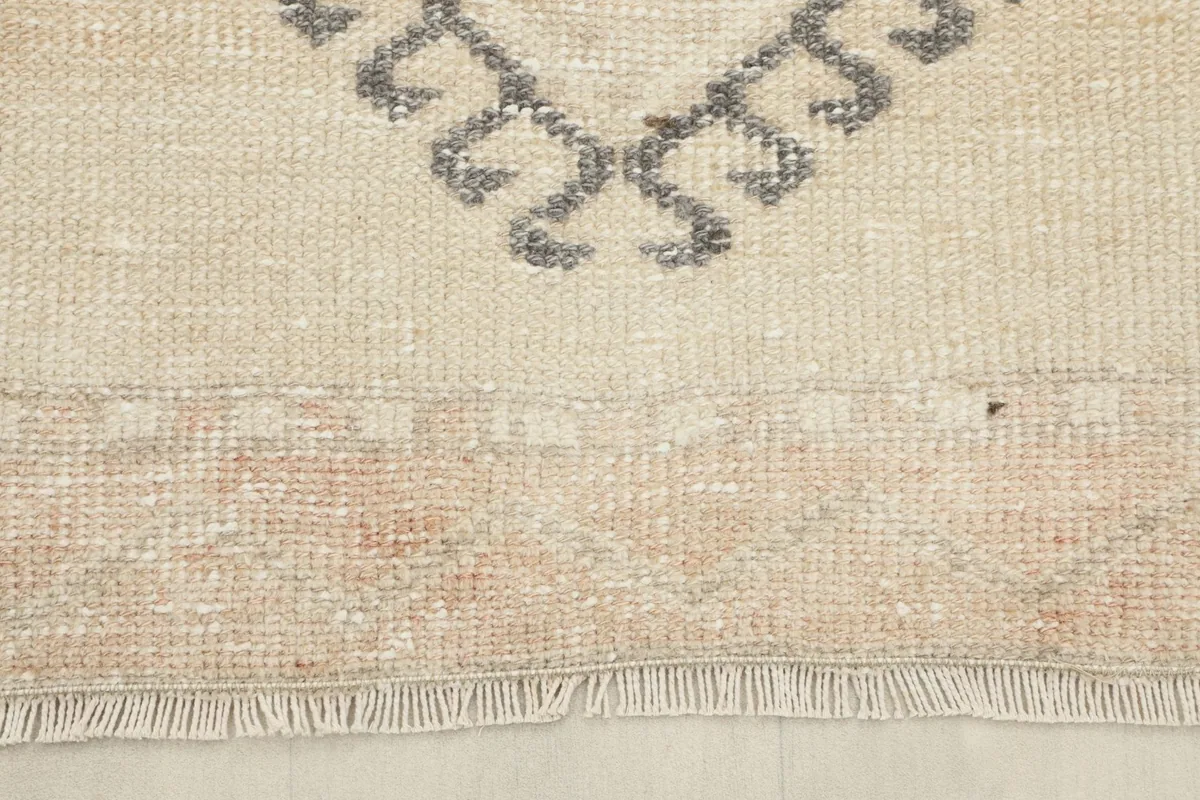 Detail of the short, natural fringes and the border design at one end of the vintage runner.