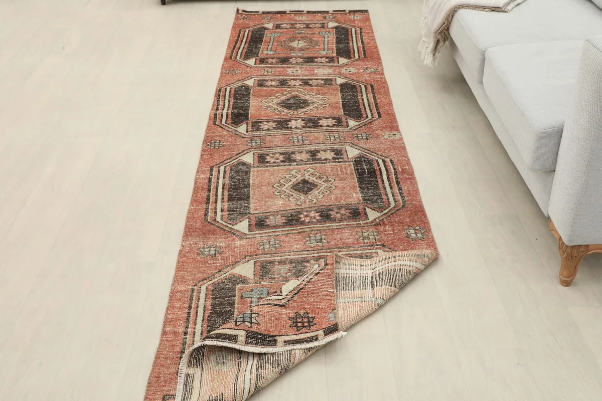 Long view of the runner in a room, with one end slightly folded to show the back construction.