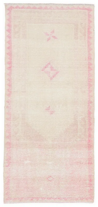 Full overhead view of the 2'8" x 5'11" ivory and pink vintage Anatolian rug