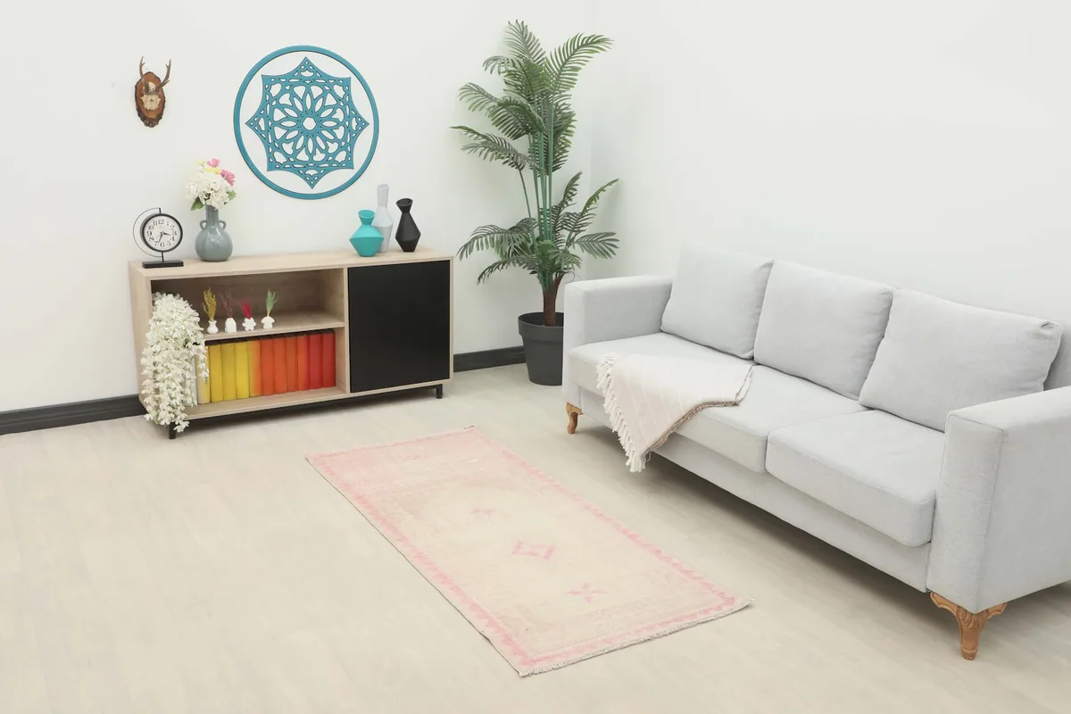 Ivory and pink vintage Anatolian rug styled in a living room setting