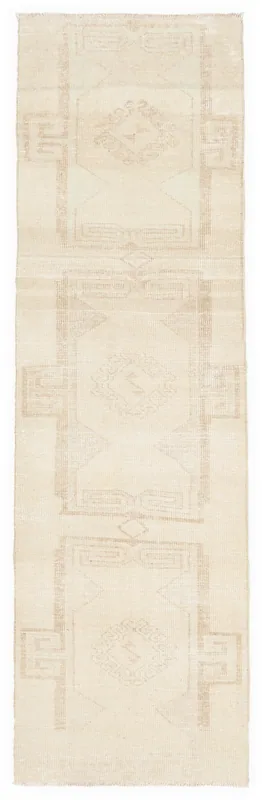 Full overhead view of the 2'9" x 9'3" cream and tan vintage runner rug