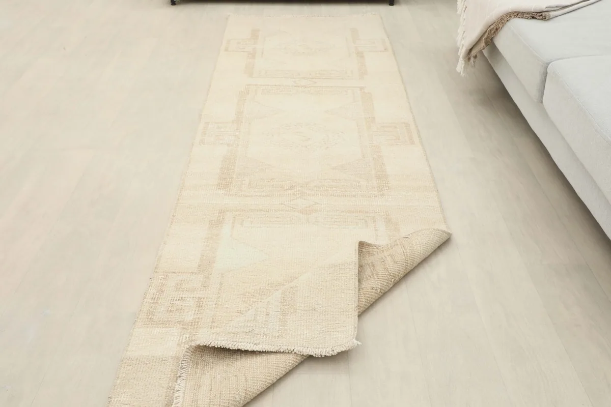 Runner rug partially folded to demonstrate its flexibility and construction