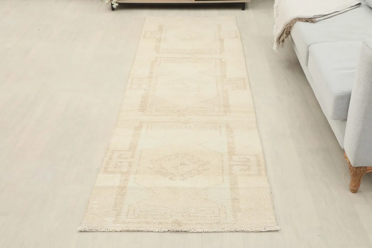 Overhead view of the cream runner rug laid out in a room