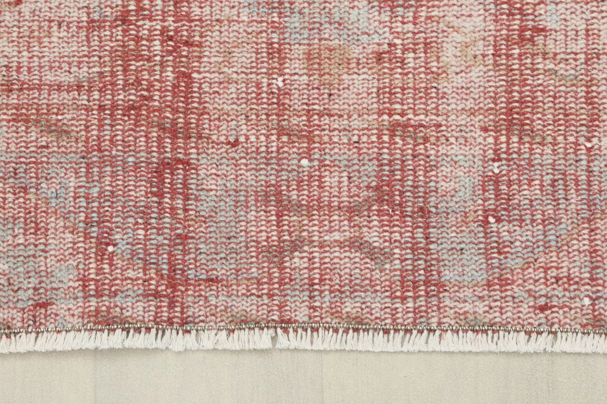 Close-up of the short, white cotton fringes at the end of the vintage Anatolian rug.