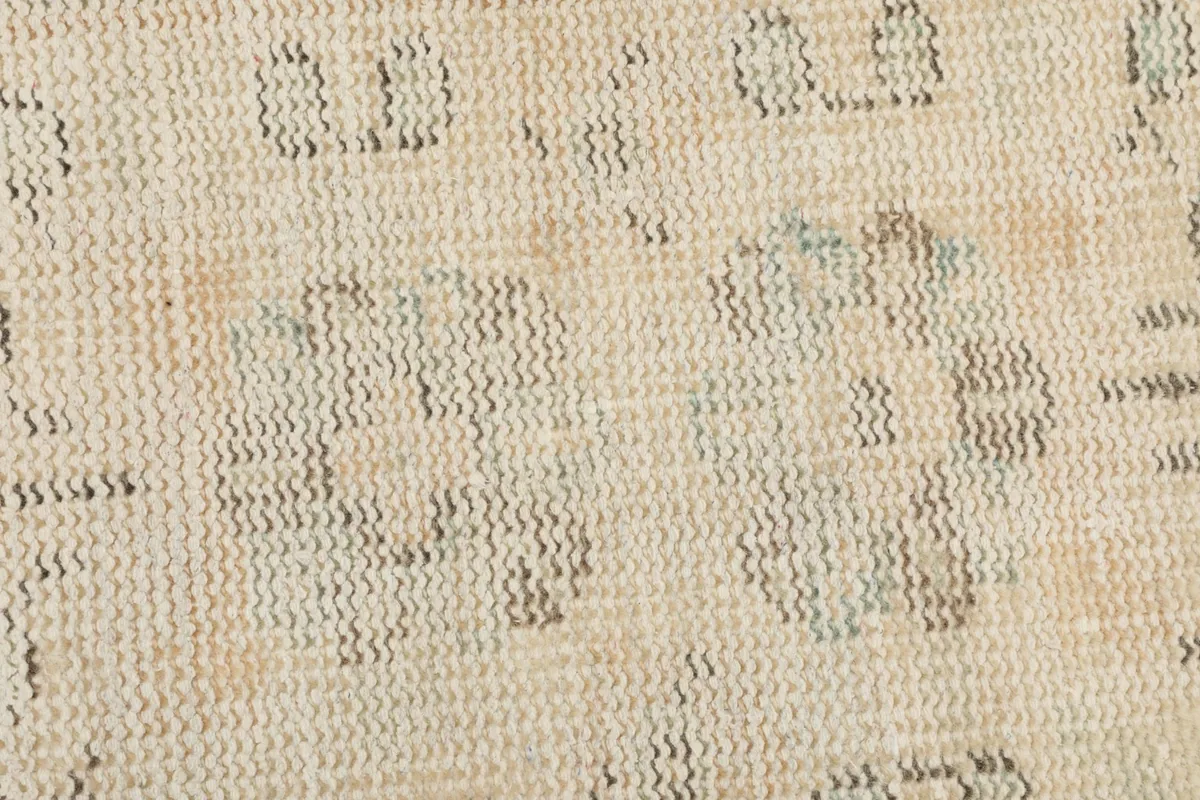 Extreme close-up of the hand-knotted wool pile, showing texture and individual knots