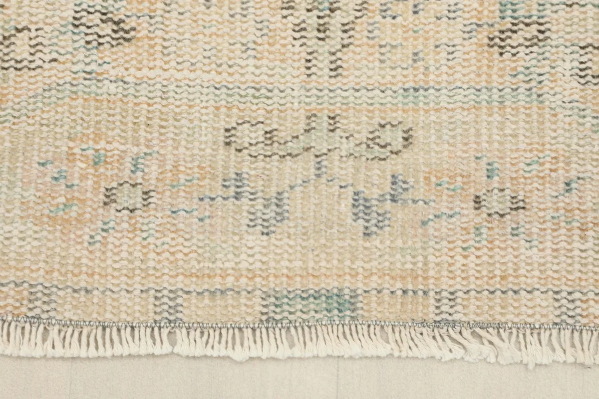 Close-up of the fringe and border design at one end of the vintage Anatolian rug