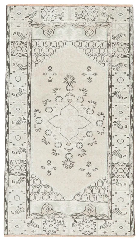 Full overhead view of the ivory and gray geometric Anatolian vintage rug