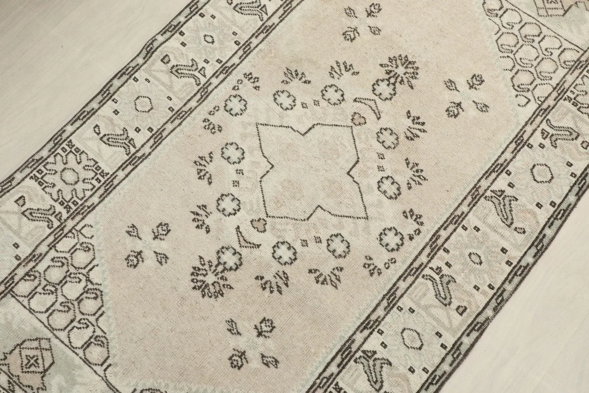 Detailed view of the central geometric motif and surrounding floral-like elements
