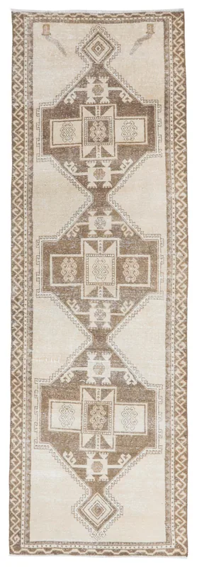 Full overhead view of the beige and brown geometric vintage Anatolian runner rug.