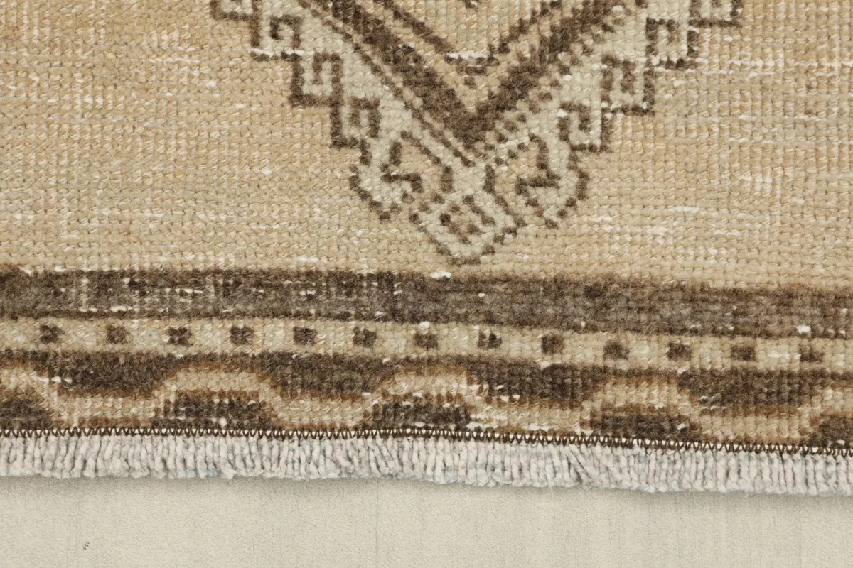 Close-up of the fringe and the patterned border of the vintage Anatolian runner rug.