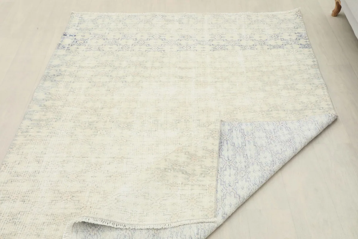 Rug corner folded to reveal the underside, showcasing the sturdy cotton foundation
