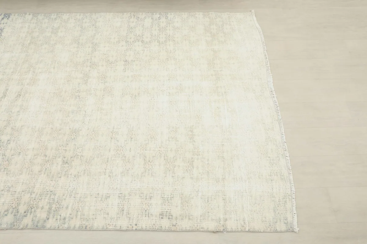 Overhead view of a section of the rug, highlighting its faded geometric design