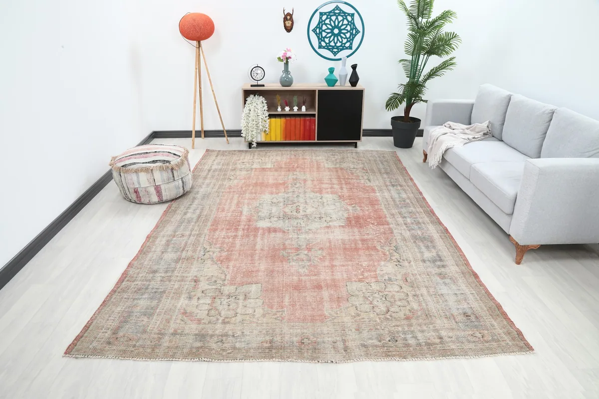 Vintage Anatolian area rug displayed in a modern living room setting, showing its large size