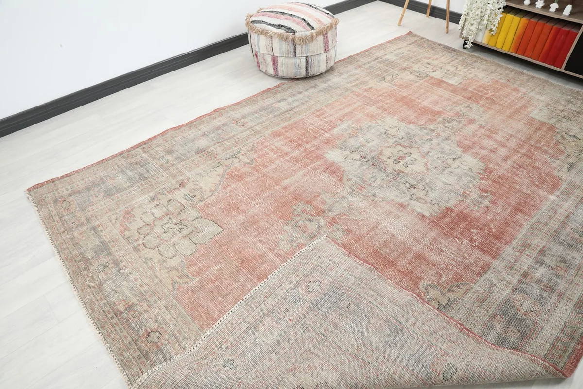 Corner of the rug folded back, showing the cotton foundation and the reverse side of the knotting