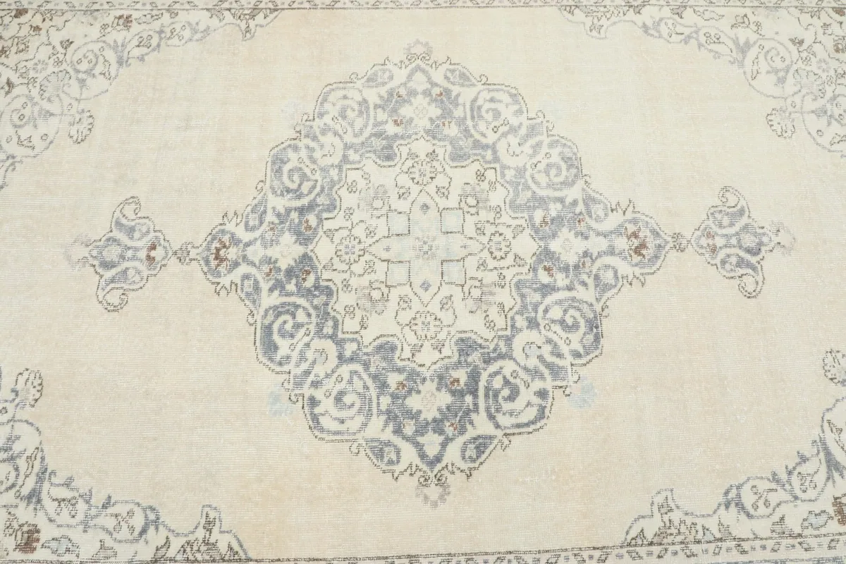 Close-up of the central gray medallion, showing its faded texture and intricate design.