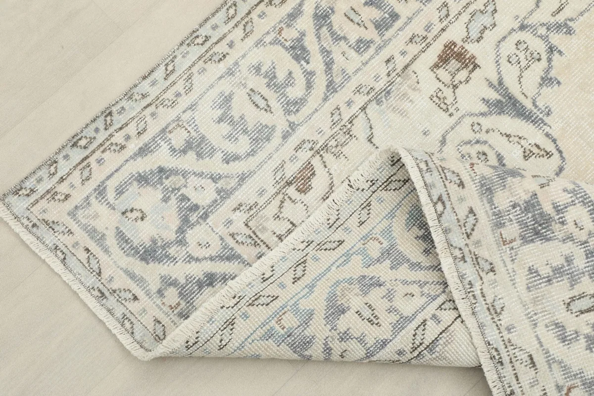 The vintage rug folded to show the flexibility of its hand-knotted wool pile and cotton foundation.