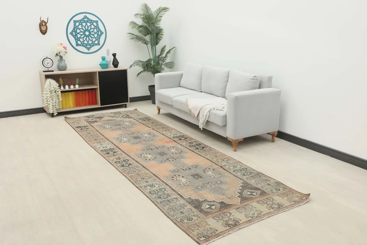 Runner rug laid out in a modern living space with a light gray sofa and wooden furniture, showing its overall scale.