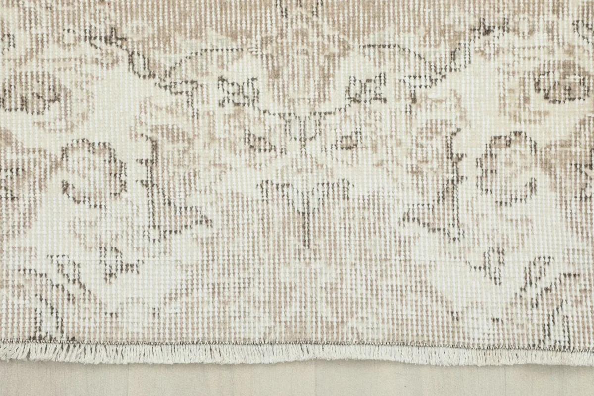 Detail of one end of the rug, showing the border design and the short, finished fringe