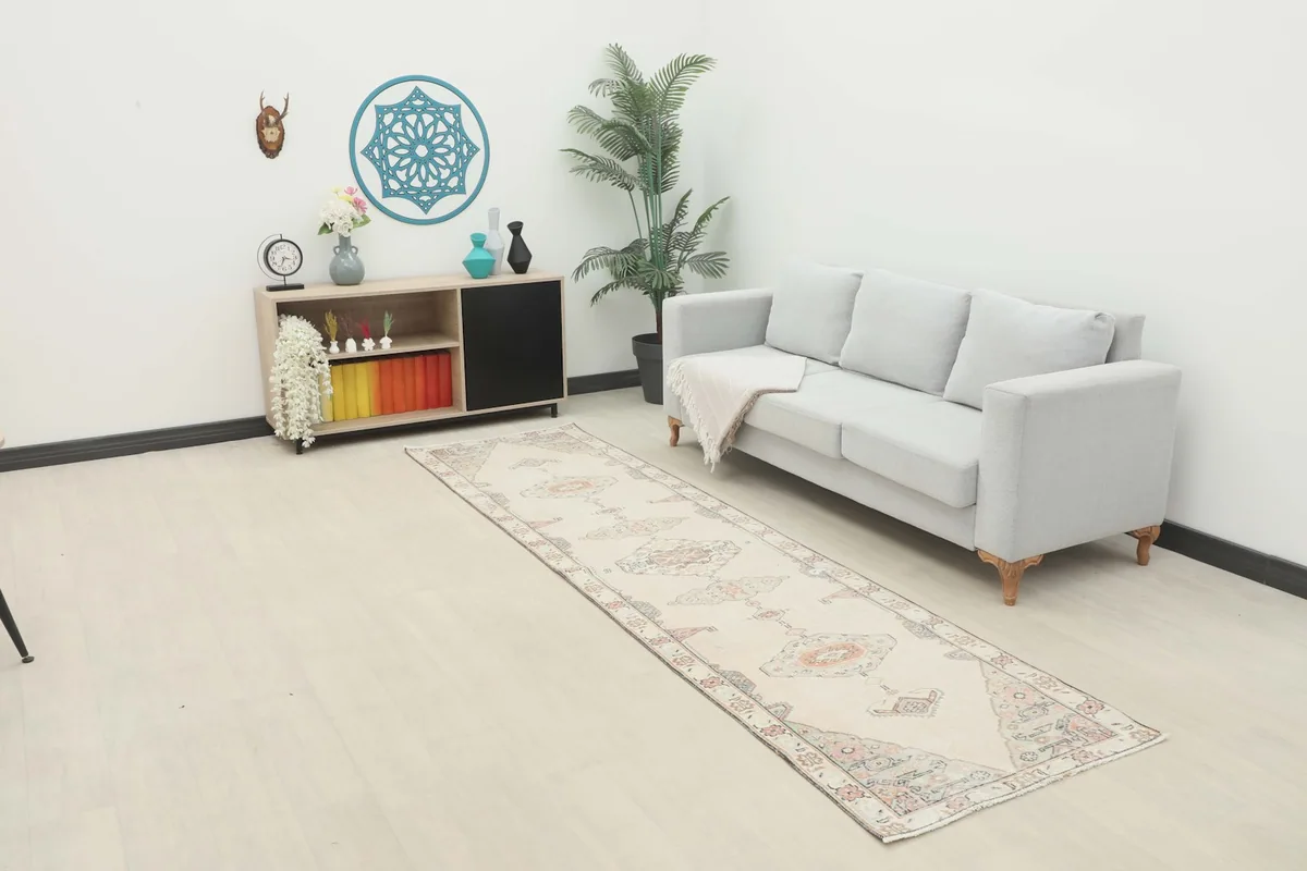 Vintage Anatolian runner rug in a modern living room setting next to a gray sofa