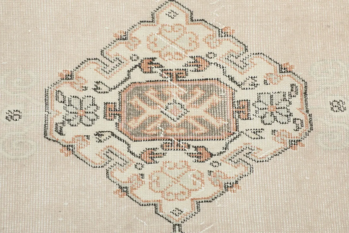 Close-up of a central medallion design, showing intricate geometric details and color variations