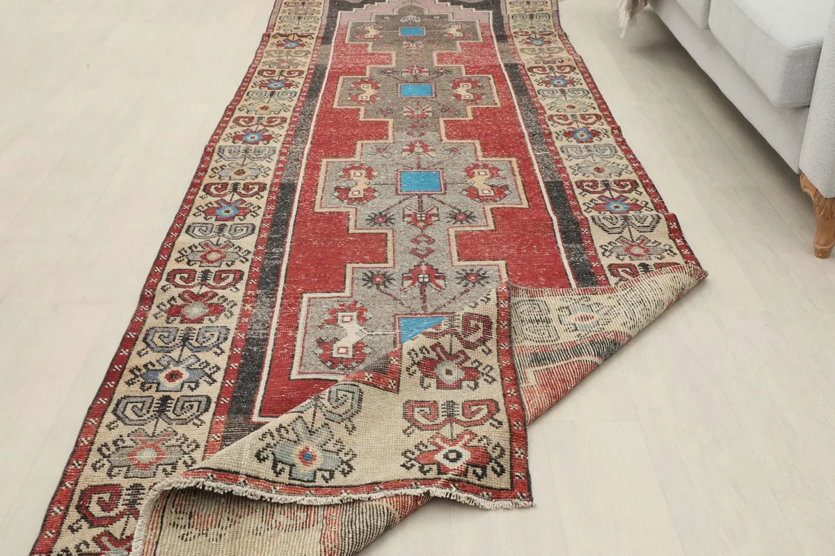 Runner rug partially folded, displaying the full length and the reverse side of the corner
