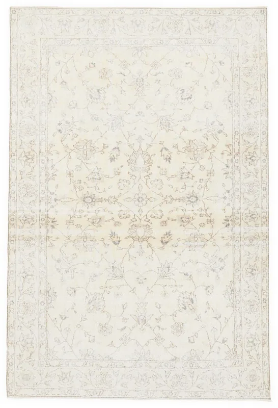 Full overhead view of the ivory floral Anatolian rug on a white background