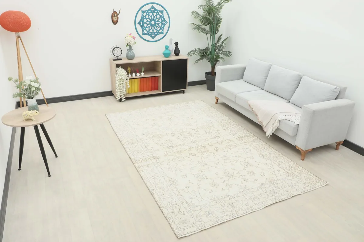 Ivory rug displayed in a modern living room setting with a gray sofa