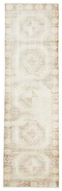 Full overhead view of the beige geometric vintage runner rug on a white background