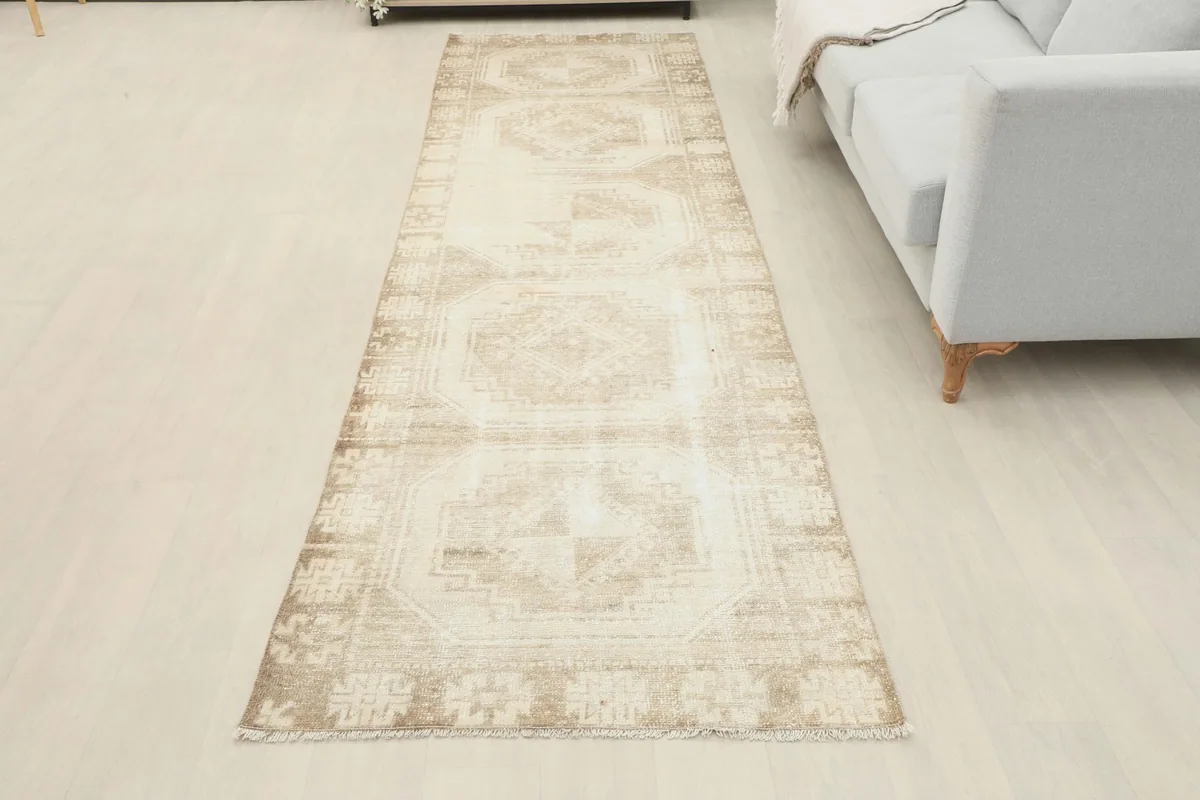 Full overhead room view of the vintage beige runner rug, showcasing its placement
