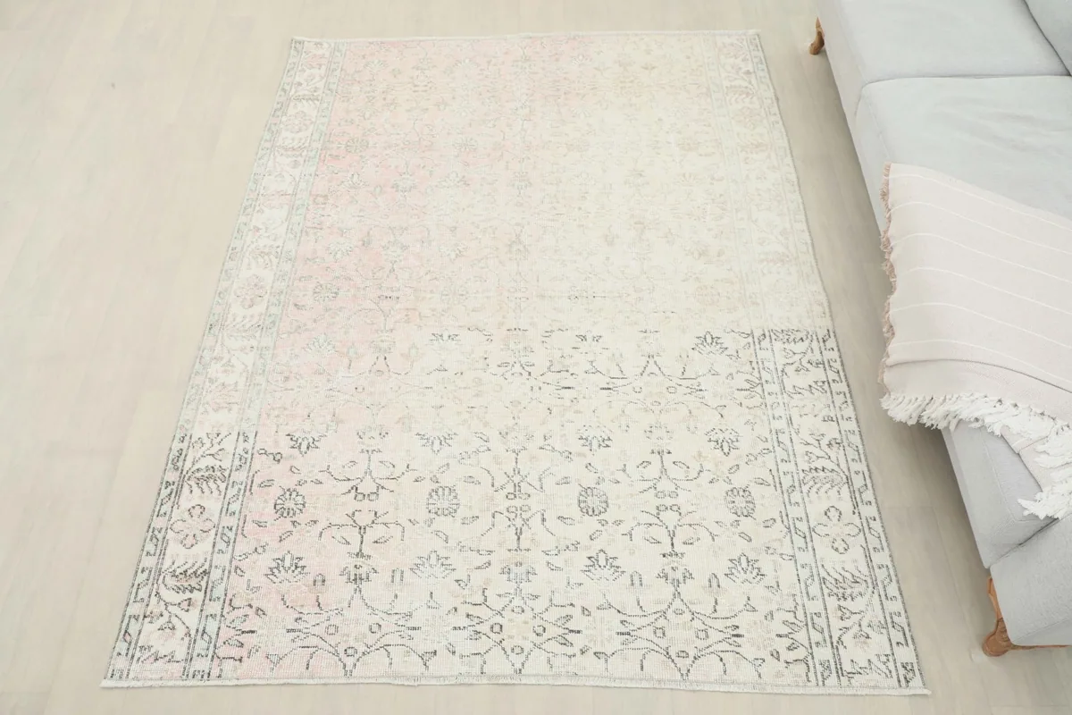 Full view of the rose and ivory Anatolian rug in a room, offering a sense of scale and placement