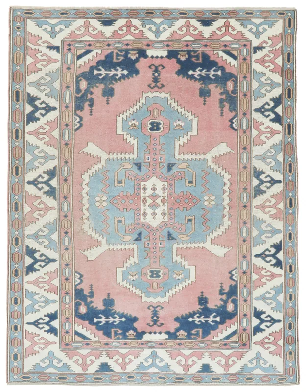 Full overhead view of a vintage Anatolian wool rug with rose field and geometric tribal patterns
