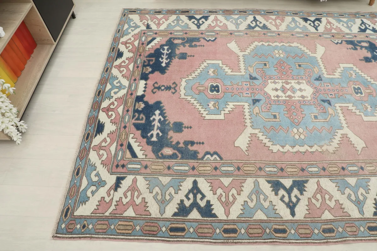 Angled view of the rug's surface, highlighting the rose, blue, and navy color variations