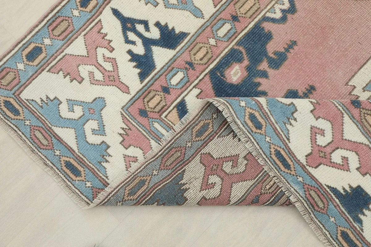 Folded corner of the rug, showing the back of the hand-knotted cotton foundation