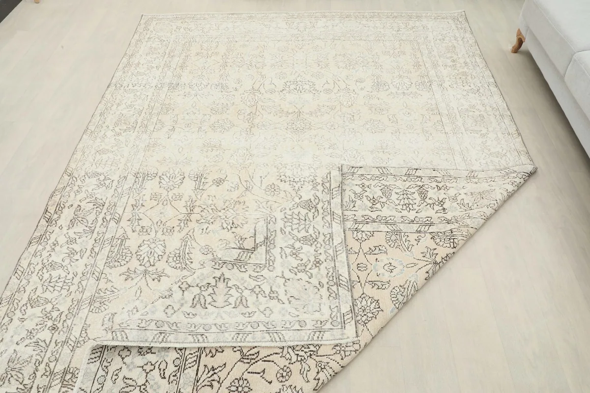 View of the rug's underside, revealing the hand-knotted cotton foundation and wool pile