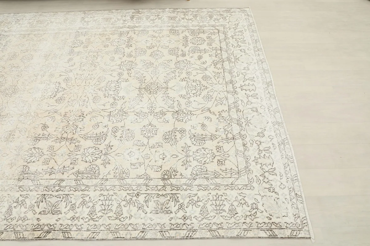 Overhead view from one corner of the ivory gray rug, showing the distressed wool pile