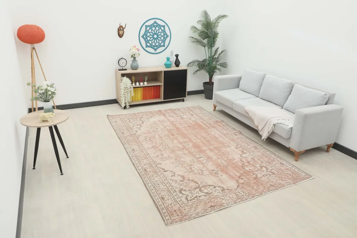 Vintage rose and beige Anatolian rug in a contemporary living room setting