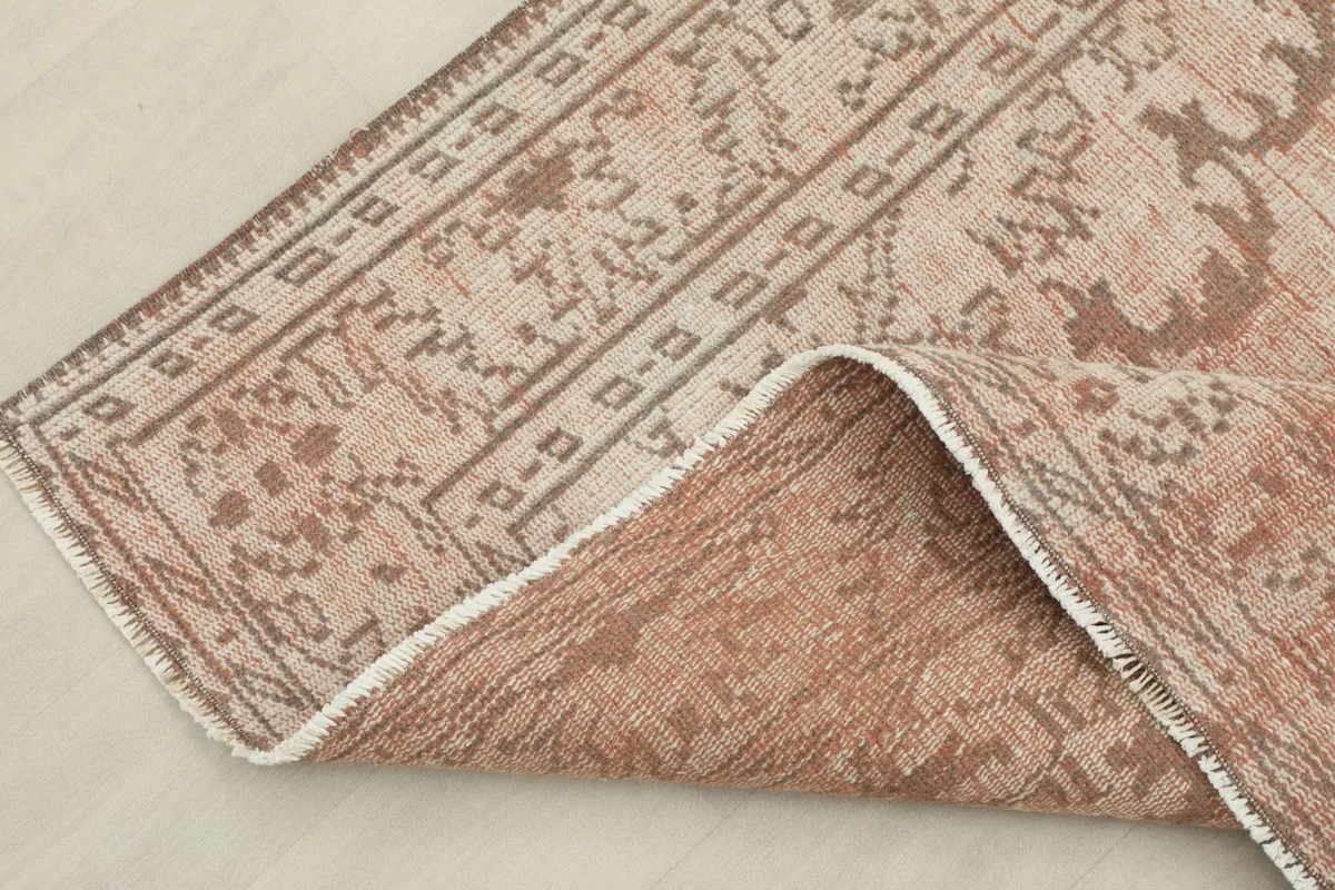 View of the rug's underside, revealing the hand-knotted cotton foundation