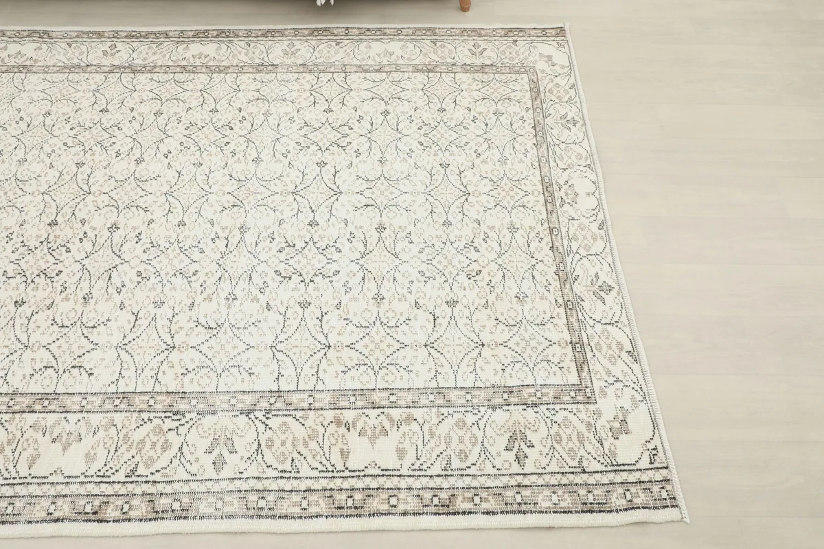Close-up angled view of the rug's corner, highlighting the detailed geometric border and field