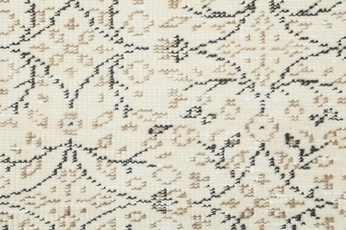 Close-up of the low wool pile, revealing the texture and slight wear of the vintage rug