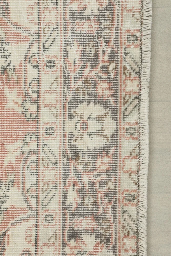 Detail of the rug's border design, showing the transition to the edge and fringe