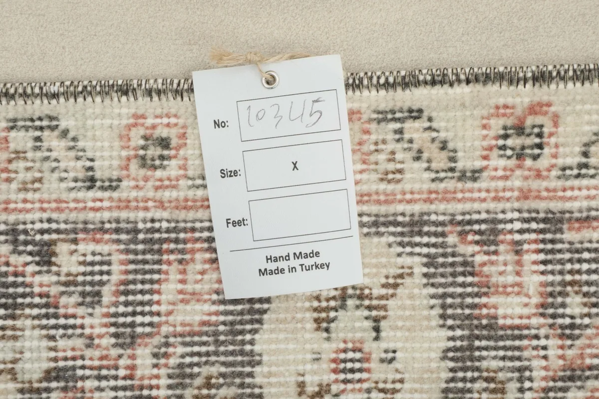 Back of the rug with a product tag, showing the hand-made in Turkey label