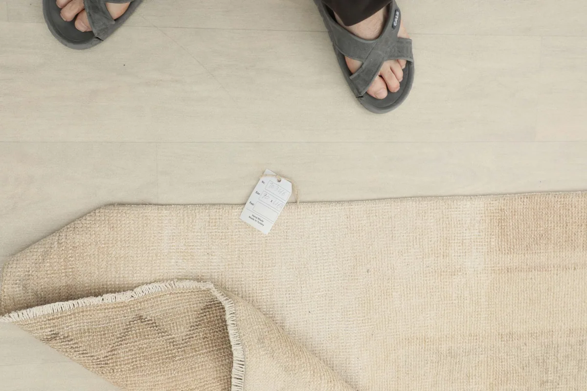 Overhead view showing a person's feet next to the runner rug, indicating scale.