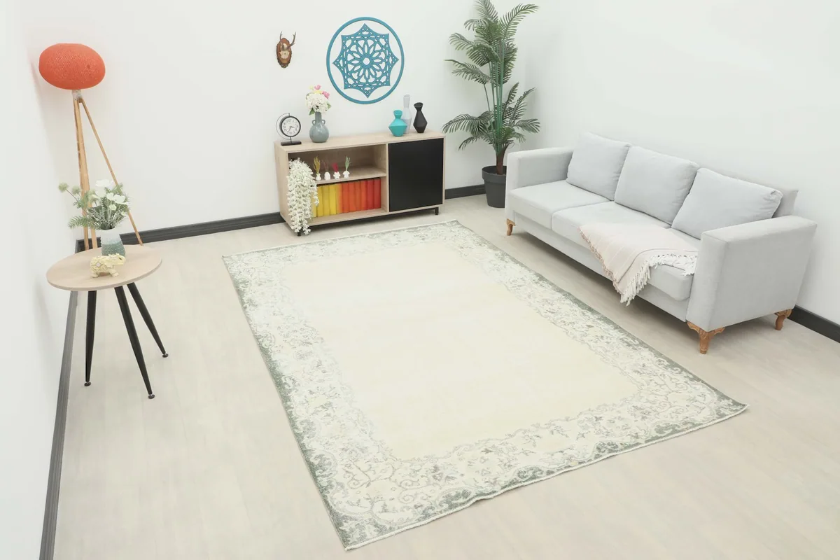 Vintage Anatolian rug displayed in a bright living room setting with a light gray sofa