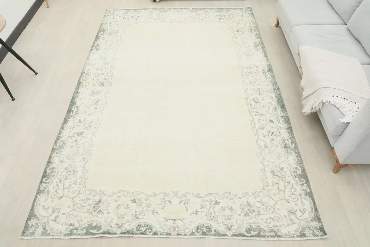 Full view of the ivory and gray Anatolian rug in a room, offering a sense of its overall presence
