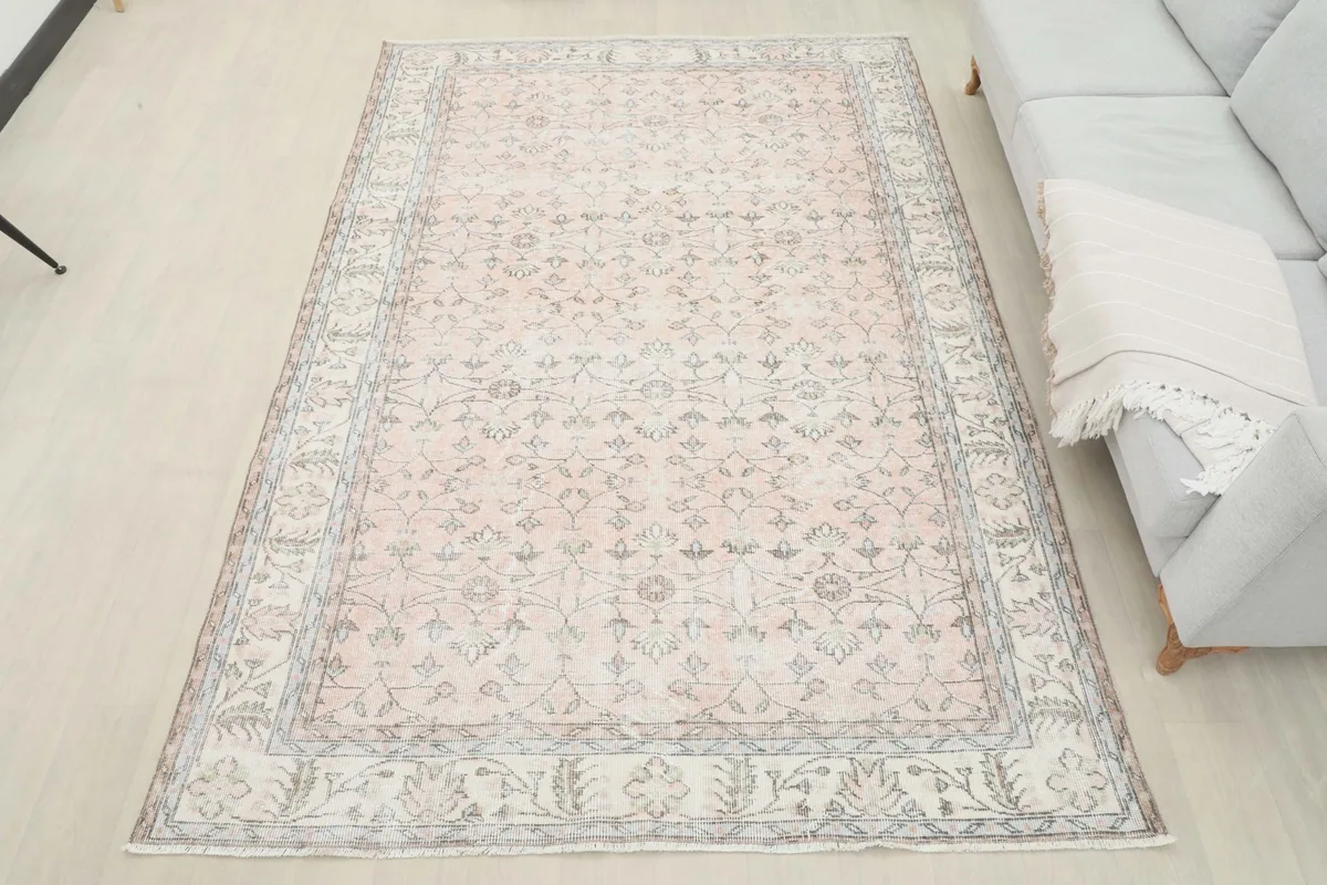 Overhead view of the vintage soft rose rug in a living room setup
