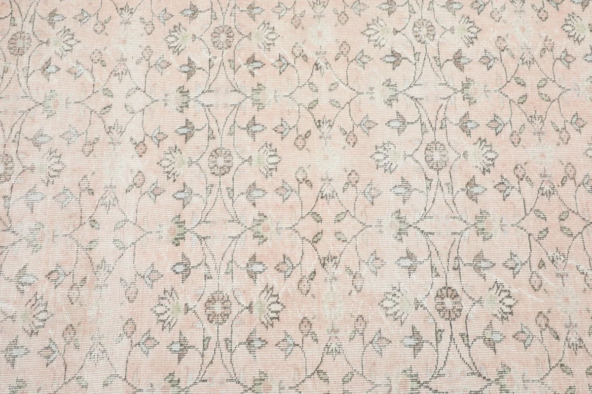 Close-up of the rug's main field with intricate gray floral patterns