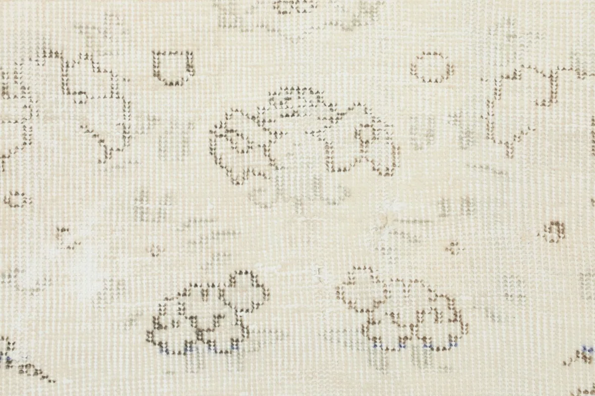 Close-up view of the low wool pile and the intricate hand-knotted texture of the rug