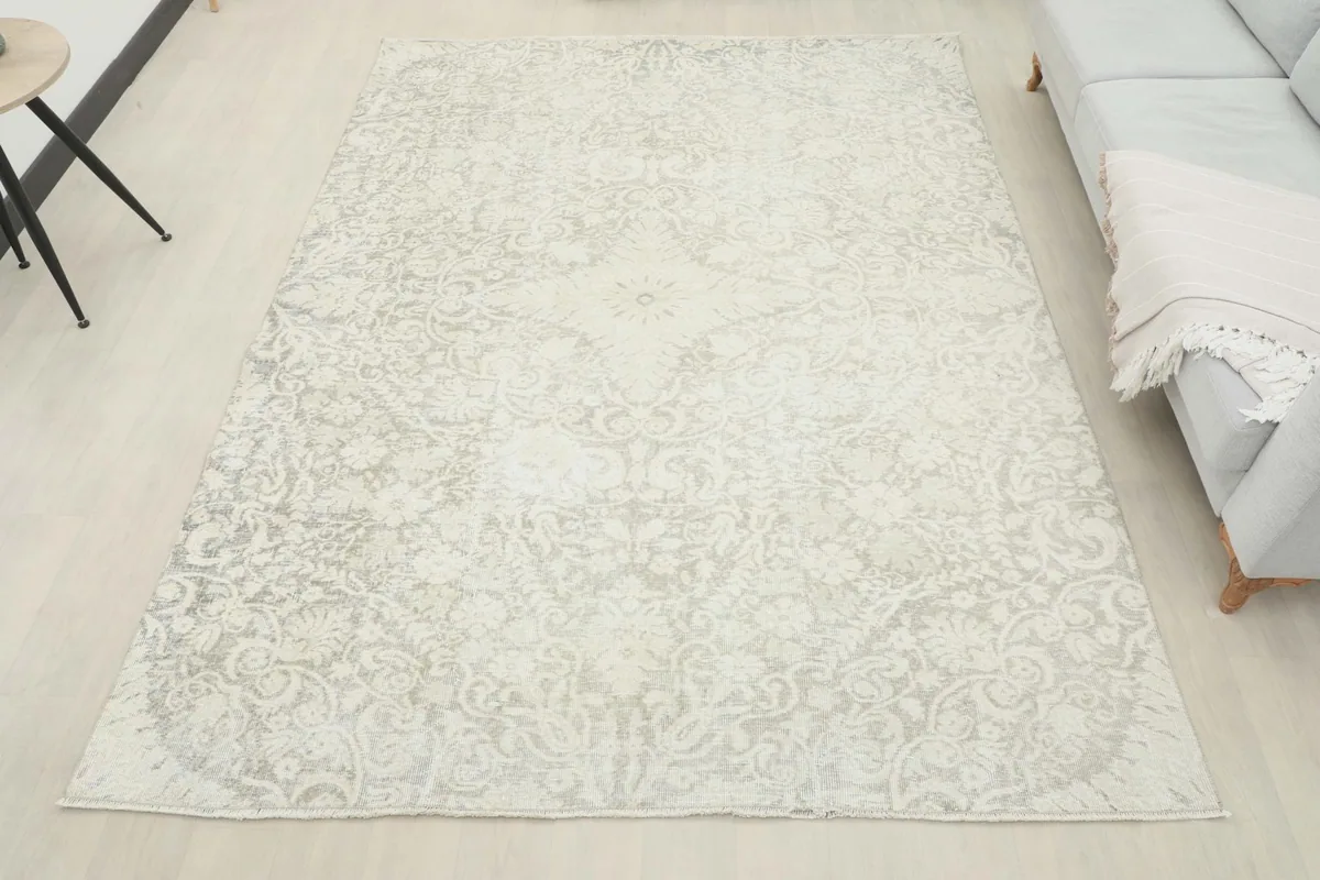 Full overhead view of the vintage ivory and gray rug in a staged room setting