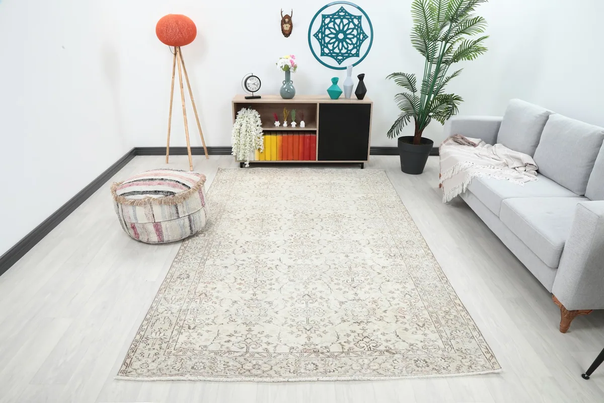 Ivory area rug displayed in a bright living room setting with a sofa and decor