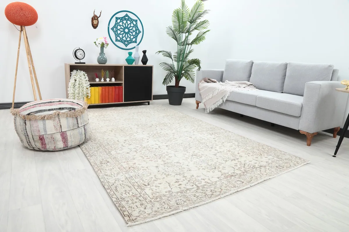 Angle view of the ivory rug in a living room, showing its placement relative to furniture